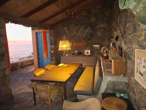 a living room with a table and a couch at Casa Praia Tarrafal de Monte Trigo in Seladinha
