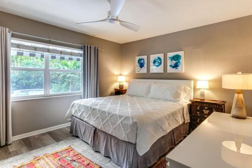 a bedroom with a bed and a window at 1 Mi to Lake Worth Beach Park Poolside Paradise! in Lake Worth