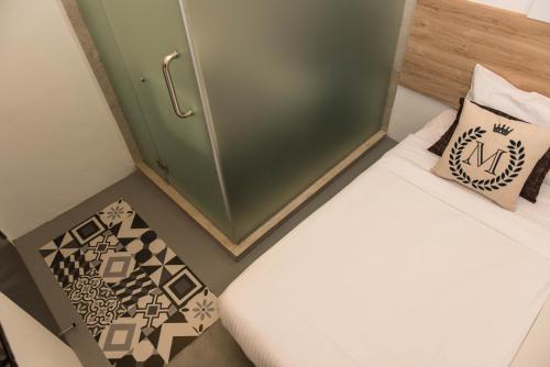 a small room with two beds and a green cabinet at Mixx Express Hotel Sunway in Petaling Jaya