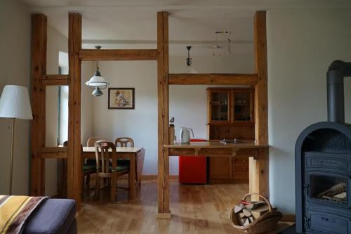 a living room with a wood stove and a table at Oben im Selketal in Harzgerode
