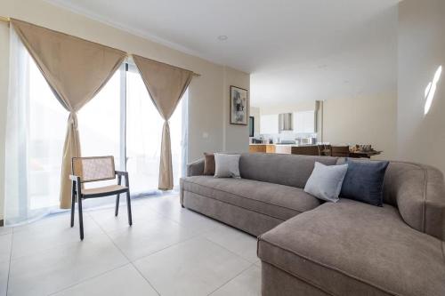 a living room with a couch and a chair at Casa Florencia Ensenada Home 3BR WIFi & BBQ 10 Guests in Ensenada