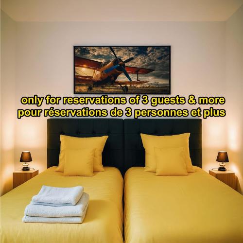 two beds sitting next to each other in a room at Riverside Toulouse (Savory) in Blagnac