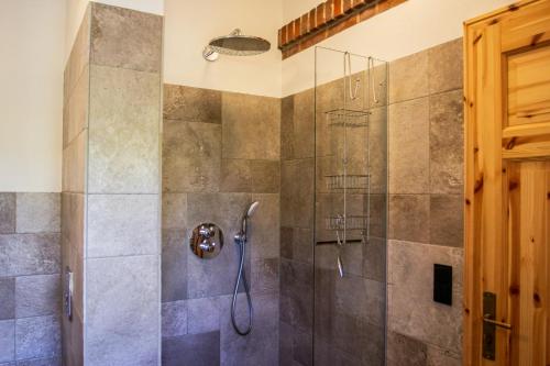 a shower with a glass door in a bathroom at Idyllic Country House Between Hamburg And Berlin in Langen Jarchow