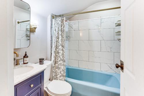 a bathroom with a toilet and a sink and a shower at Cozy Home 4 Mi to YSU Campus Penguins Welcome! in Boardman