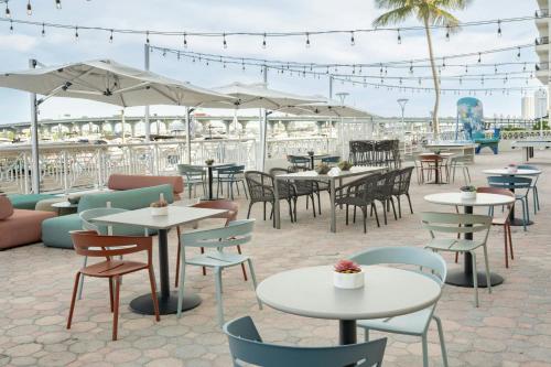 an outdoor patio with tables and chairs and umbrellas at Miami Marriott Biscayne Bay in Miami