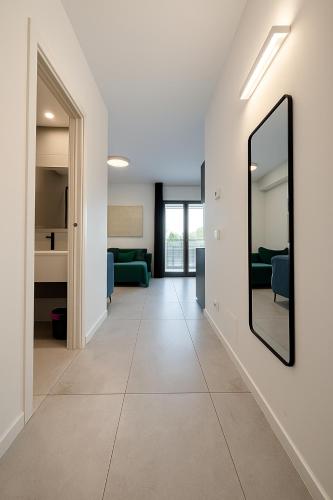 a hallway with a mirror and a living room at Marisabella Suite Spa 2 in Bari