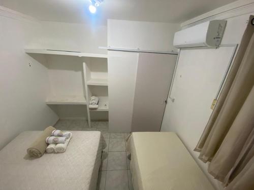 a small kitchen with a white refrigerator and shelves at COP 30 - Imóvel Próximo ao Aeroporto e ao Hangar - 02 in Belém