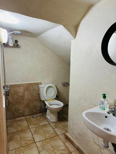 a bathroom with a toilet and a sink at Caban Surf in Tamraght Ouzdar