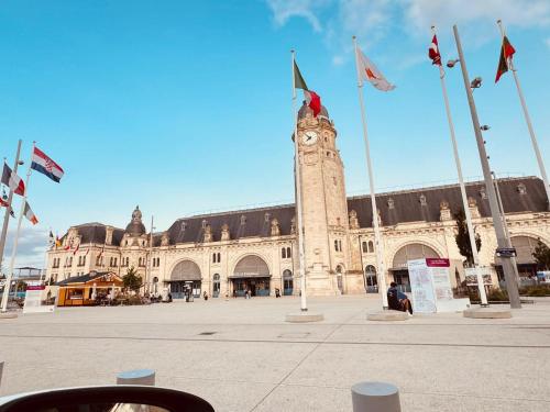 a large building with a clock tower in front of it at LoveroomL1TIMISTE TAR in La Rochelle