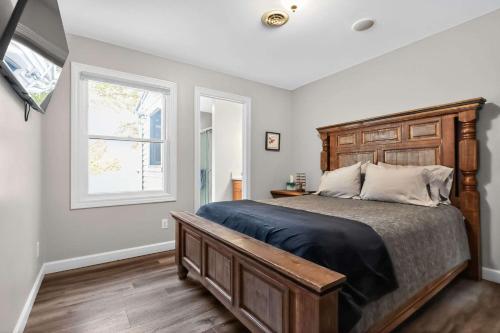 a bedroom with a large bed and a window at Pet-friendly Grass Lake Hideaway in Grass Lake
