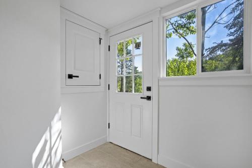a white door in a room with windows at The Enchanted Summit in Cripple Creek