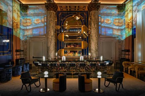 a bar in a room with chairs and tables at W New York - Union Square in New York