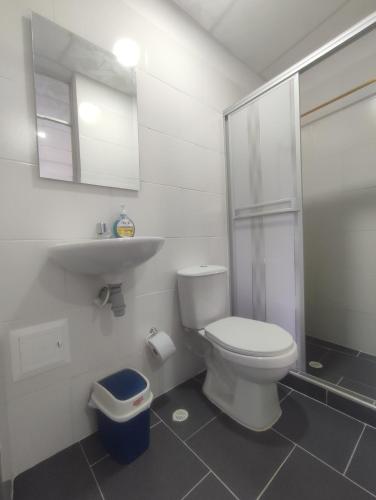 a bathroom with a toilet and a sink and a shower at Hotel YUMA TATACOA in Villavieja