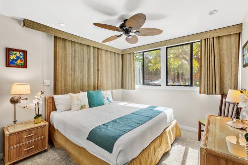 a bedroom with a bed and a ceiling fan at Mahina Surf 117 in Kapalua