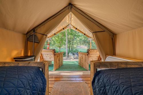 a tent with two beds and a view of a yard at Nature Retreat Cozy tentHVACSpa Bath in Newport