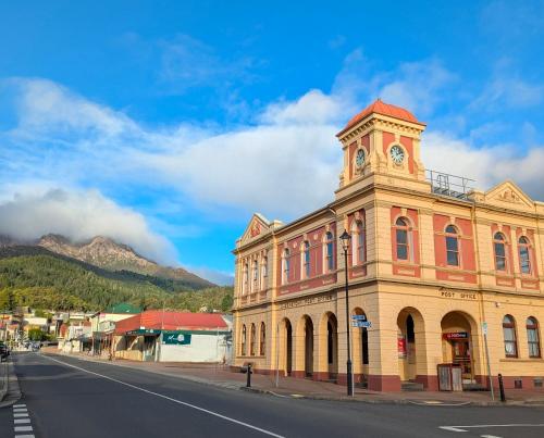 a building with a clock tower on a street at Quentin's Cottage in Queenstown