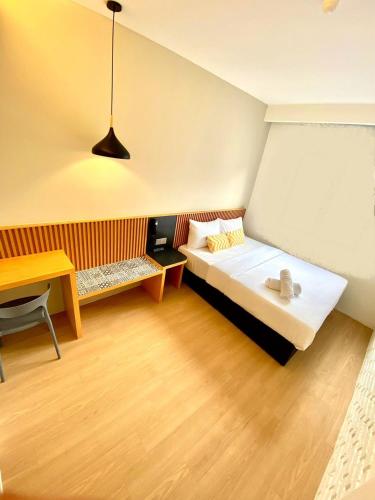 a bedroom with a bed and a table and a desk at Mixx Express Hotel Sunway in Petaling Jaya