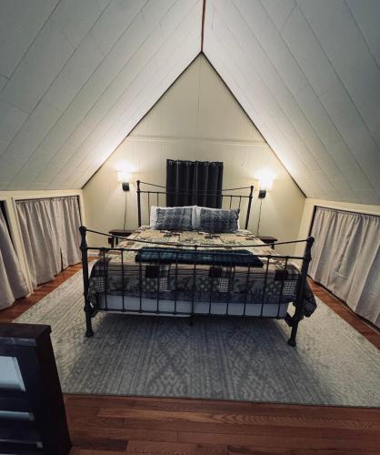 a bedroom with a bed in a attic at Home in Arrowhead Lake Pocono PA - Lake Access, Hot Tub, Fire Pit, and Amenities Included in Arrowhead Lake