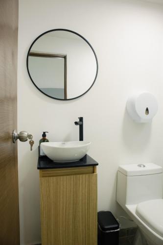 a bathroom with a sink and a mirror on the wall at Casa solare in Medellín