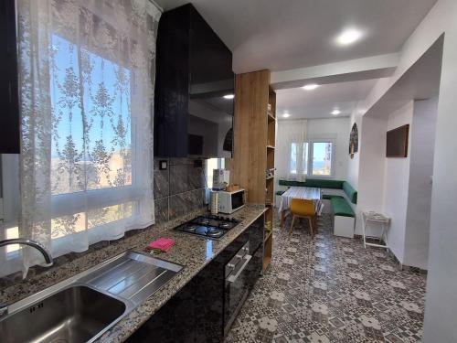 a kitchen with a sink and a counter top at villa Mauresque vue sur la baie d'Alger 