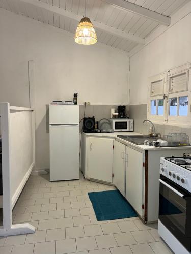 a kitchen with white appliances and a stove top oven at Logement à trois rivières à 5min de l embarcadère in Trois-Rivières