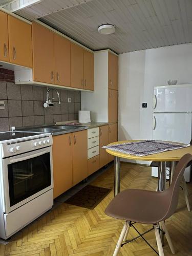 a kitchen with a table and a table and a stove at TRUTH Apartment Veles in Veles