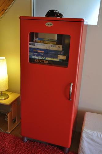a red refrigerator with a television on top of it at Flygarevägen in Höllviken