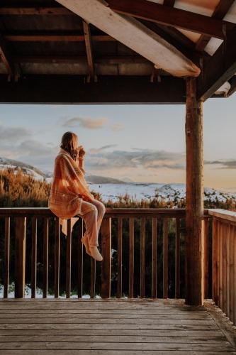 a woman jumping in the air while talking on a cell phone at Alpine Haven, Peaceful , Stunning Views - ML21396 in Mt Lyford