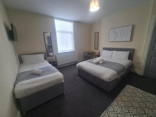 a hotel room with two beds and a window at Park Place Collection in Sunderland