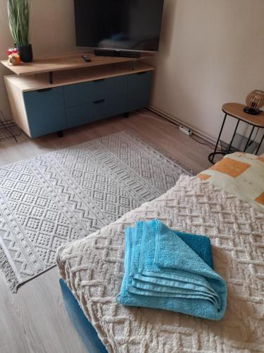 a bedroom with a bed with a blue towel on it at Mieszkanie w centrum Gogolina in Gogolin