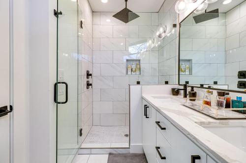a white bathroom with a shower and a sink at Chic Austin House with Spacious Backyard and Hammock in Austin