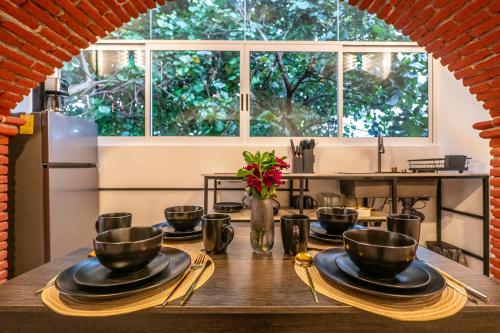 a table with plates and bowls on top of it at Apartment in Convention Center, Oaxaca in Oaxaca City