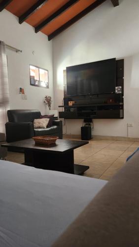 a living room with a large flat screen tv at Sala en Casa Familiar para 2 personas in Asuncion