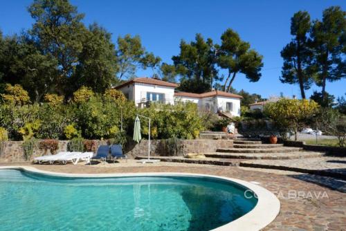 a large swimming pool in front of a house at Villa Sotavent in Vall-Llobrega