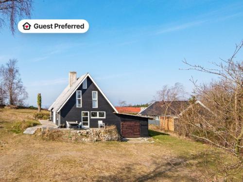 a house on a hill with the words guest preferred at 6 person holiday home in Ebeltoft in Ebeltoft
