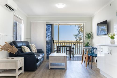 a living room with a couch and a table at The Pelican Caravan Park Nambucca Heads in Nambucca Heads