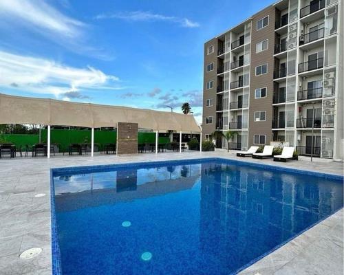 a large blue swimming pool in front of a building at Habitacion Cowboy in Monterrey