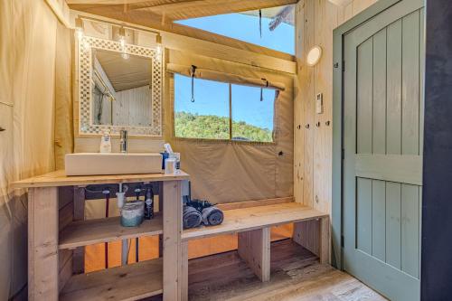 a bathroom with a sink and a mirror at Nature Retreat Cozy tentHVACSpa Bath in Newport