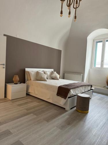 a white bedroom with a bed and a window at Ad un Passo dal Duomo in Bovino