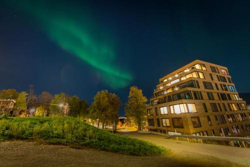 an apartment building with the aurora in the sky at Modern Apartment in Tromsø Center in Tromsø
