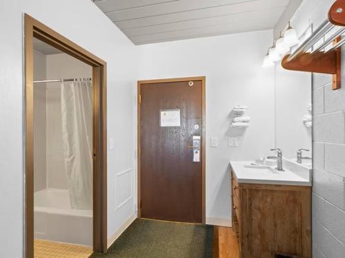 a bathroom with a shower and a toilet and a sink at 1st Choice Inn of Rawlins in Rawlins
