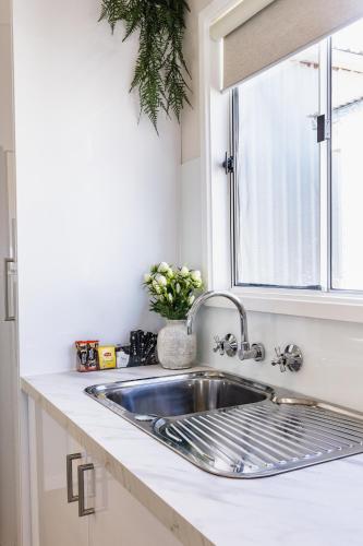 a kitchen sink in a kitchen with a window at The Pelican Caravan Park Nambucca Heads in Nambucca Heads