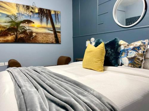 a bedroom with a bed with a painting on the wall at Topaz Classy, Cozy Condo Near Beaches & Airport in Crown Point