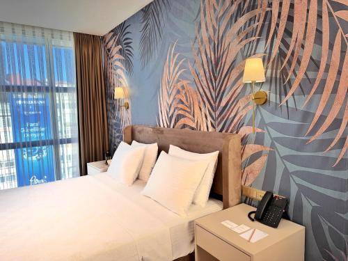 a hotel room with a bed with a phone on it at Park Dedeman Sisli in Istanbul