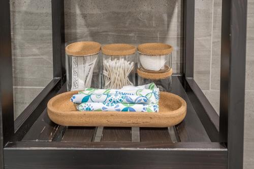 a shelf with dishes and other items in a drawer at Modern 2BR - 2 Full Bathrooms - Trendy Location in Montréal