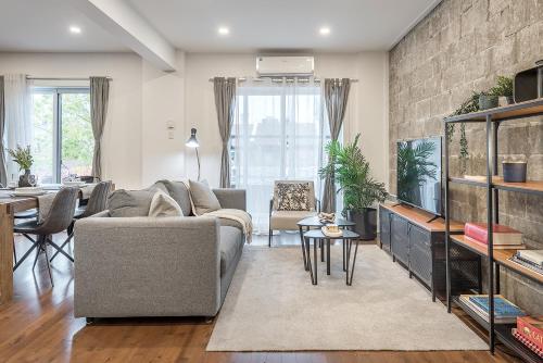 a living room with a couch and a fish tank at Modern 2BR - 2 Full Bathrooms - Trendy Location in Montréal