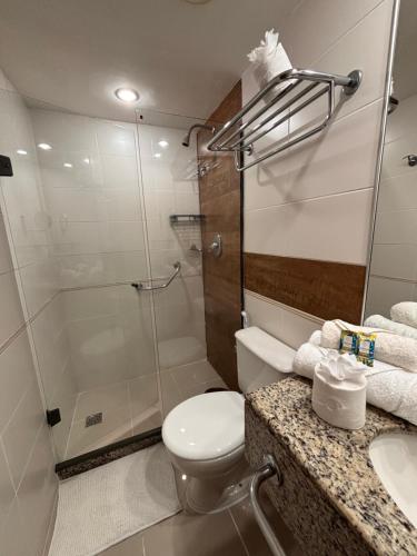a bathroom with a shower and a toilet and a sink at Flat Barra Residence-3 pessoas-Fa1204-4 in Rio de Janeiro
