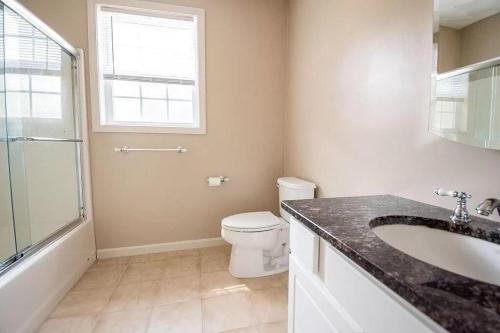 ワーウィックにあるLake Shore Houseのトイレ、洗面台、窓のあるバスルーム