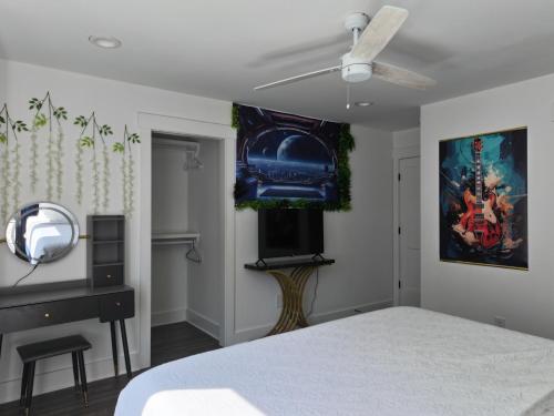a bedroom with a bed and a ceiling fan at New Elevations Rooftop 5 Min to Downtown Nash in Nashville