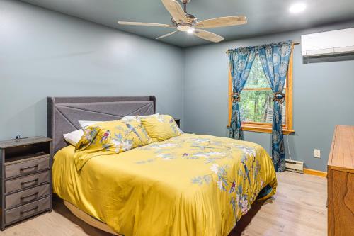a bedroom with a bed and a ceiling fan at 9 Mi to Hickory Ski Center Wooded Warrensburg Gem in Bolton